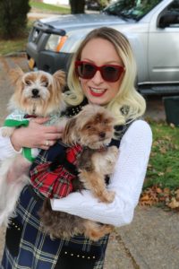 Kristin Stec smiles and holds her dogs.