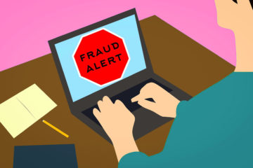 illustrated image of a person sitting at a laptop with a fraud alert on the screen